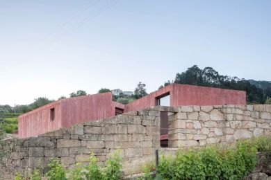 a modern concrete house set within a ruin